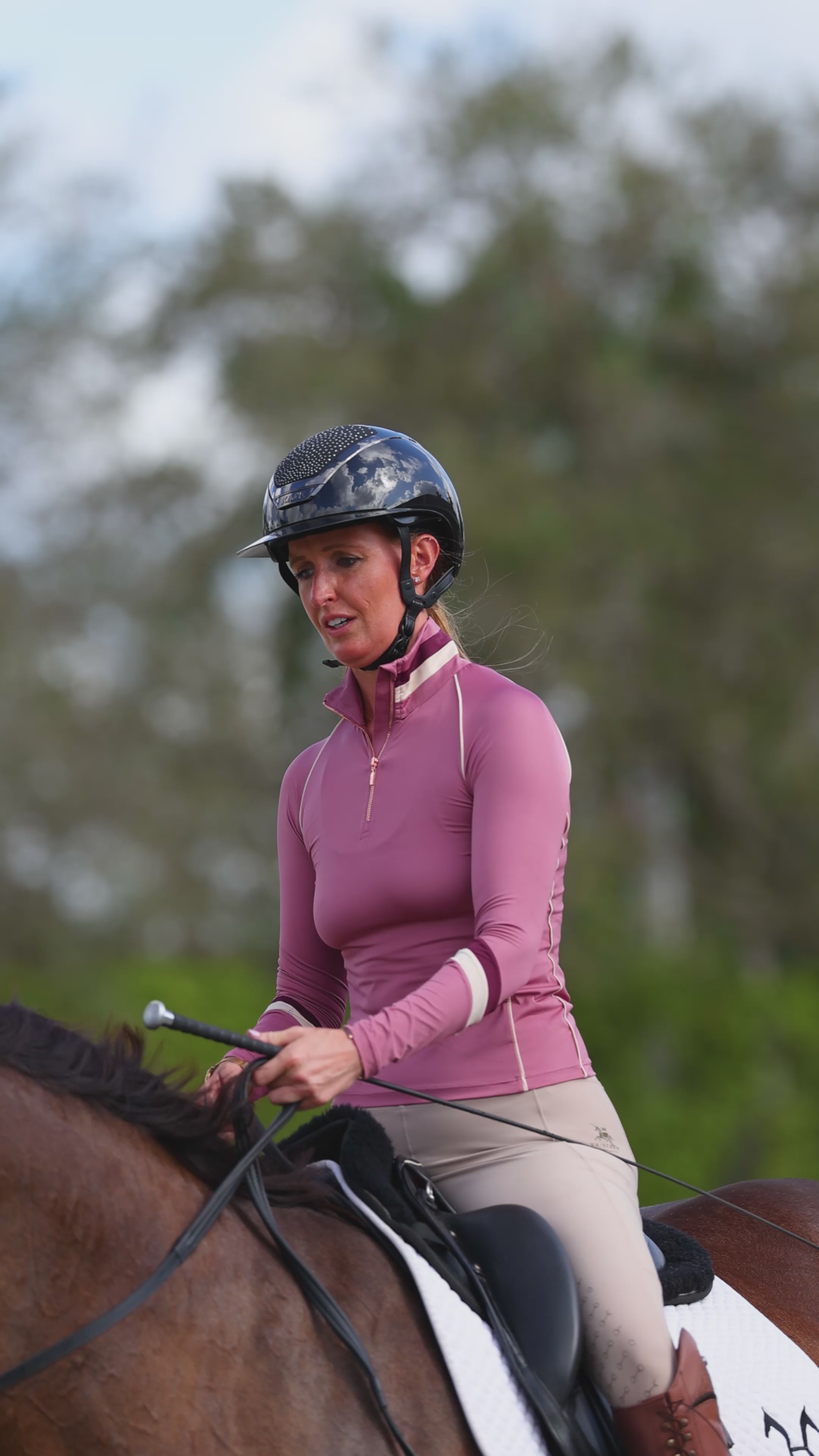 Adriane Alvord wearing the Uniqcorn Exceptionnel Very Berry Equestrian Sun Shirt and Hunter High-Rise Full Seat Tights.